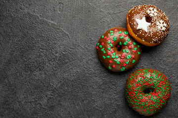 Tasty Christmas donuts on dark background