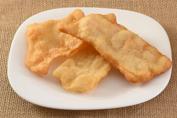 Puff pastry, flakes on a white porcelain plate