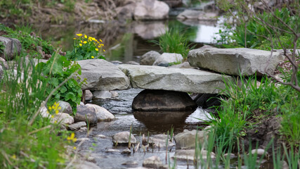 Fototapeta na wymiar Small rock bridge on the creek in rural Michigan