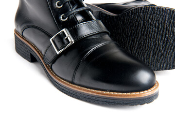 women's black boots with a lace-up buckle and low heels. Close-up