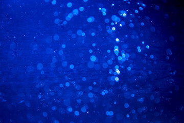 Abstract blur blue sparkle bokeh with black background