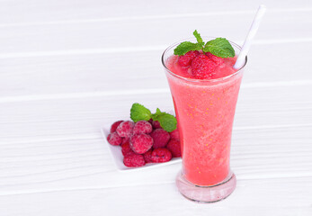 Raspberry smoothie red colorful fruit juice milkshake blend beverage healthy high protein the taste yummy In glass drink episode morning on white wood background.