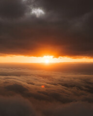 Fototapeta na wymiar sunburst between clouds during a beautiful sunset