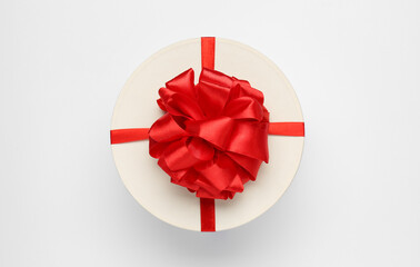 Gift box with red bow on white background, top view