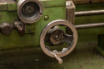 A wheel off an engineering lathe in a workshop environment. Close up. 