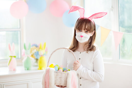 Easter egg hunt in covid 19. Kid bunny face mask.