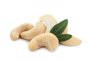 Pile of tasty organic cashew nuts and green leaves isolated on white
