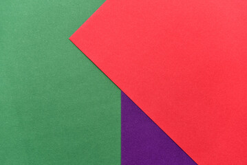 abstract geometric paper background. violet, green and red trendy colors. The backdrop for an invitation card, greeting card or web design. Creative copy space, flat lay