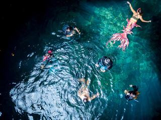 Swimmers enjoy the pristine clear waters of Cabagnow Cave, in Anda, Bohol, Philippines.