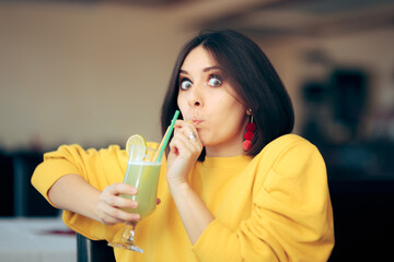 Cheerful Woman Sipping Lemonade Drink with a Straw