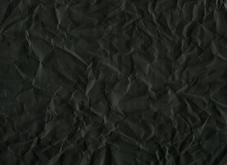 Crumpled black paper texture background