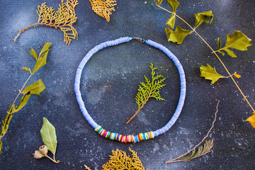 Colorful necklace, beads and stone necklace, jewelry on the blue background