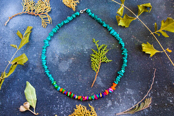 Colorful necklace, beads and stone necklace, jewelry on the blue background