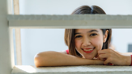 Portrait shot of Asian young happy cheerful millennial short hair teenager female model in red...