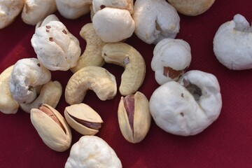 Background made of mixed nuts and raisins. Almond, pistachio and makhanas.Healthy snack and food closeup