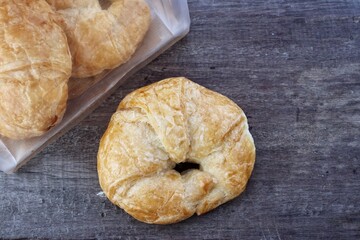 Croissant on brown wood background