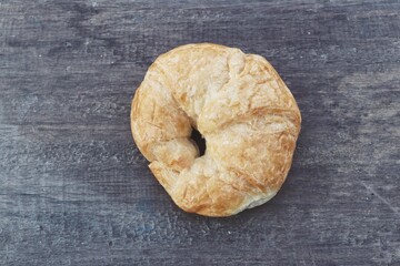 Croissant on brown wood background