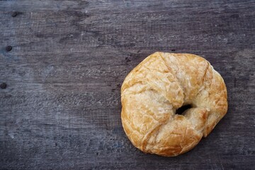 Croissant on brown wood background