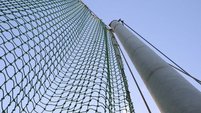 The protective net is in the baseball field.