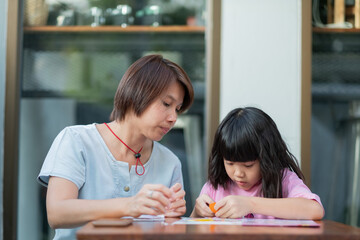 kid doing homework with mother, family concept, learning time, student, back to school