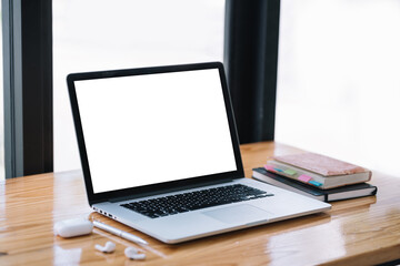 Laptop computer with blank white screen on table.