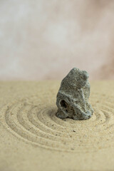 Zen sand garden meditation stone background with copy space. Stones and lines drawing in sand for relaxation. Concept of harmony, balance and meditation, spa, massage, relax