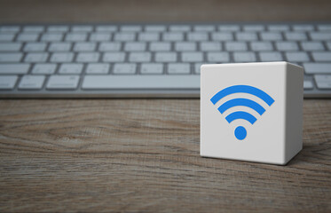 Wi-fi flat icon on white block cube with modern computer keyboard on wooden table, Technology internet communication concept