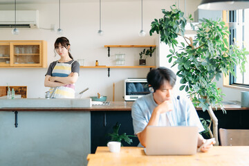 パソコンを使う男性と迷惑そうな女性（ヘッドセット）
