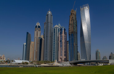 Fototapeta na wymiar skyscrapers of marina beach in dubai, Dubai Marina is an affluent residential neighborhood known for The Beach at JBR, a leisure complex with al fresco dining and sandy stretches to relax on