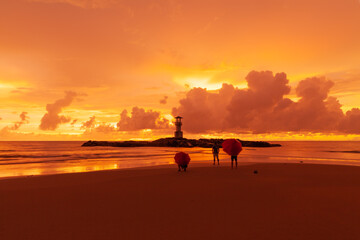 Tourists open umbrellas to watch Beautiful scenery at sunset