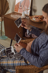 Fototapeta na wymiar Shot of beautiful young pregnant woman looking ultrasound of her Baby