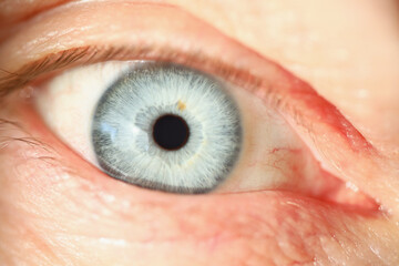 Light blue human eye colour, extreme macro shot of persons vision