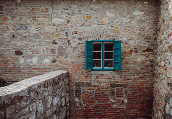 Old brick wall with window.