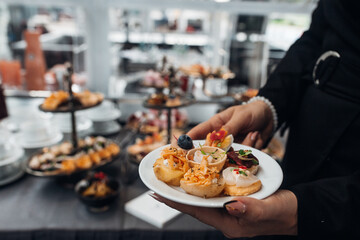 Professional waiter. Joyful man holding food while working as a waiter in the restaurant