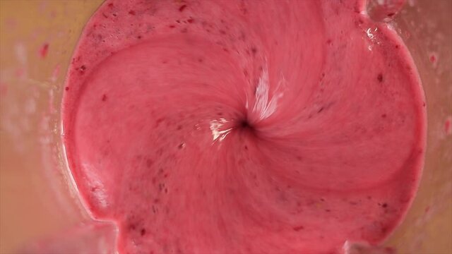 Mixing cranberry with banana in blender for vegan breakfast, top view