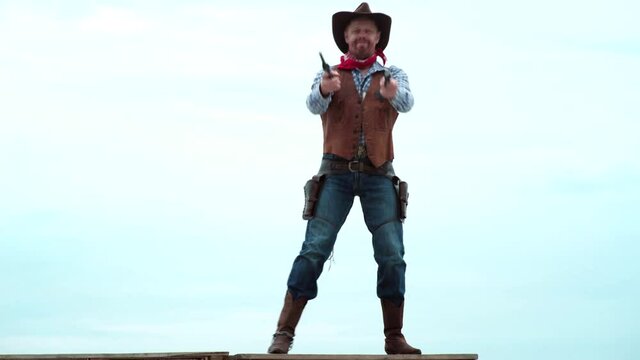 Sheriff in cowboy hat. Man with wild west guns, vintage pistol revolver and marshal ammunition. American gunslinger on wild west, guy shooting with gun revolver weapon.
