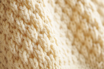 closeup beige knitted woolen fabric texture background