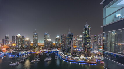 Luxury yacht bay in the city aerial night timelapse in Dubai marina