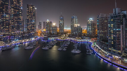 Luxury yacht bay in the city aerial all night timelapse in Dubai marina