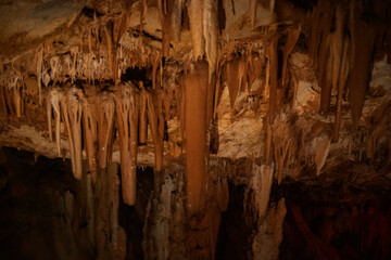 fabulous abstract background of stalactites, stalagmites and stalagnates in a cave underground, horizontal