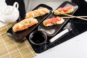 Fresh tasty sushi spring rolls with chicken and shrimps. Japanese cuisine