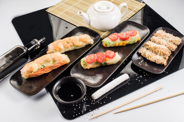 Fresh tasty sushi spring rolls with chicken and shrimps. Japanese cuisine
