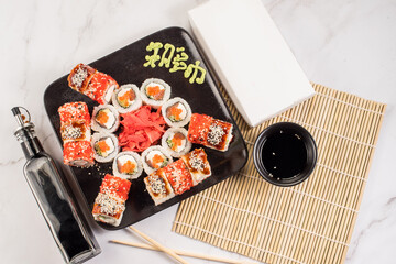 Set of different fresh tasty sushi rolls on white background