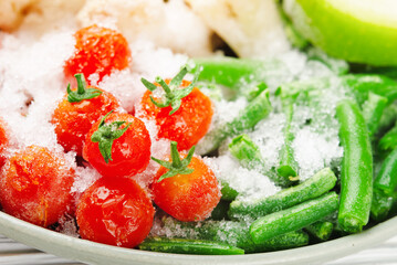 Close-up frozen vegetables cherry tomatoes and asparagus beans