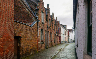 old brick historic residential houses in the Belgian city of Bruges  - 476369622