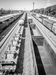 Freight railway cars at the sorting station of the city. Black and white photo. Selective focus, film grain