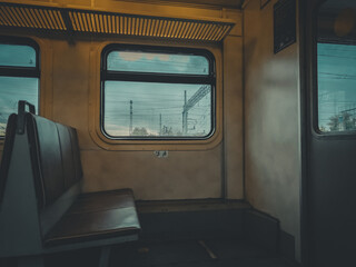 The interior of the passenger car of the electric train. Low light inside the car. Selective focus