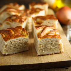 Traditional Russian cabbage pie on a wooden desk
