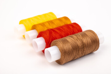 Fototapeta na wymiar Color sewing threads isolated on white background. Different colors.Bright bobbin thread.