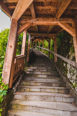 view of old empty stone stairs with wooden roof above